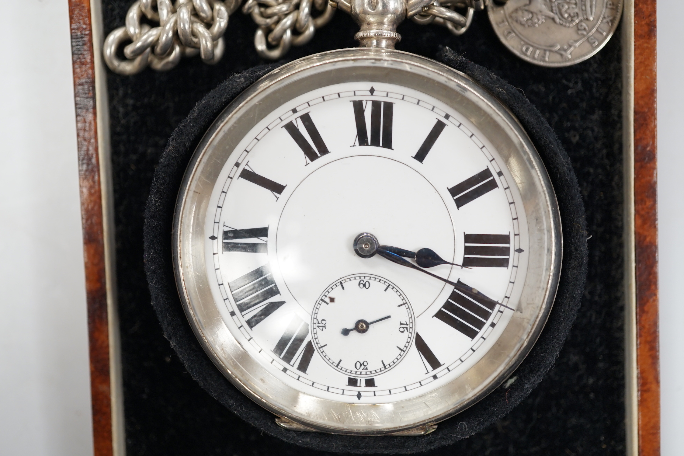 A Swiss 935 white metal open faces keyless pocket watch, with Roman dial and subsidiary second, on a silver albert.